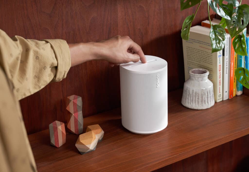 the new sonos products: sonos era 100 in white on wooden furniture with hand operated top device