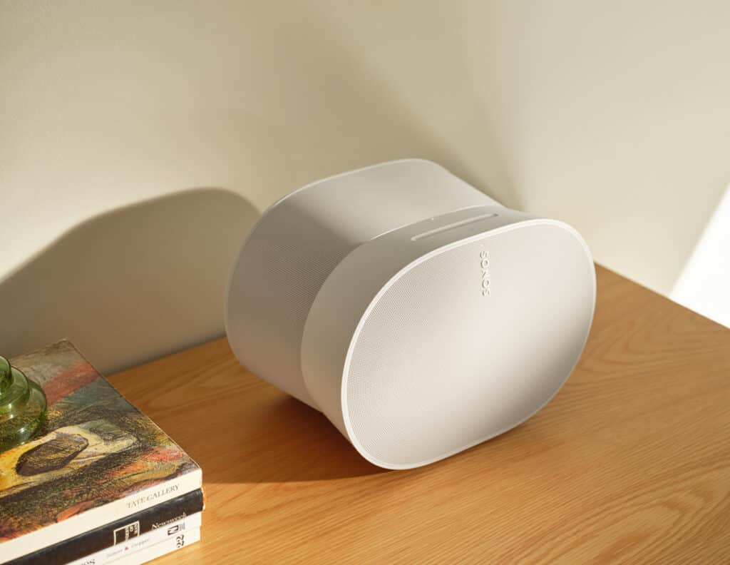 the new sonos products: sonos era 300 in white on wooden furniture