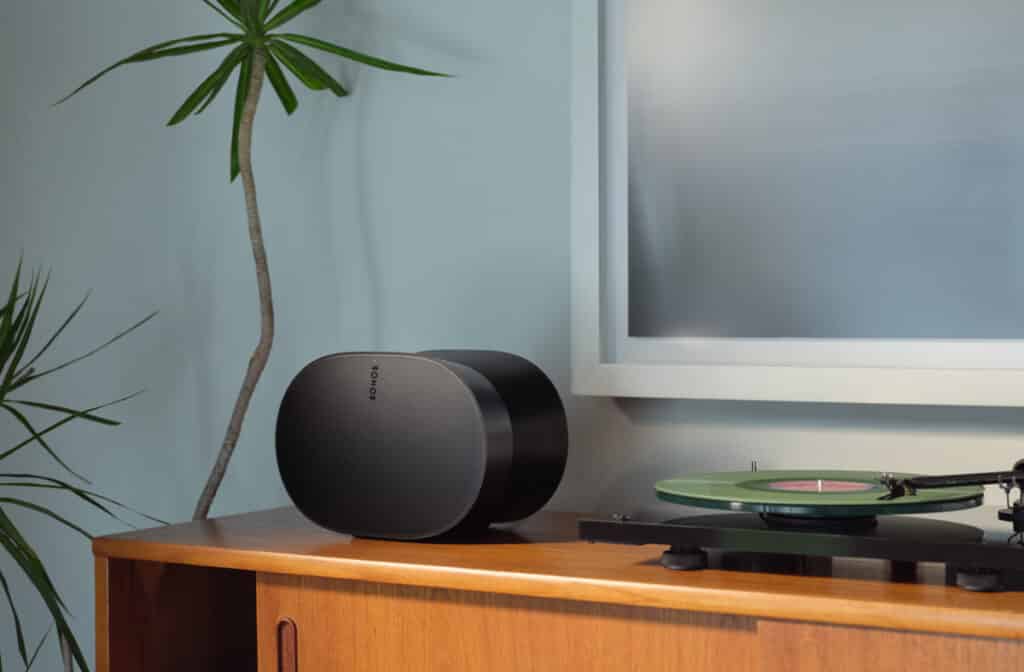 the new sonos products: sonos era 300 in black on wooden furniture